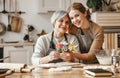 Happy mother`s day! family old grandmother  mother-in-law and daughter-in-law daughter congratulate on   holiday, give flowers Royalty Free Stock Photo