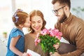 Happy mother`s day! father and child congratulate mother on holiday
