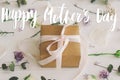 Happy mother`s day greeting card. Happy mother`s day text and gift box, lilac, roses flowers and eucalyptus leaves on white wood Royalty Free Stock Photo