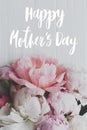 Happy mother`s day greeting card. Happy mother`s day text and  peony floral border on white wood flat lay. Stylish floral Royalty Free Stock Photo