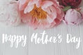 Happy mother`s day greeting card. Happy mother`s day text and  peony floral border on white wood. Stylish floral greetings. Royalty Free Stock Photo