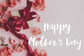 Happy mother`s day. Happy mothers day text and gift box with red flowers on pink background flat lay. Stylish floral greeting car Royalty Free Stock Photo