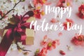 Happy mother`s day. Happy mothers day text and gift box with red and white flowers on pink background. Stylish floral greeting Royalty Free Stock Photo