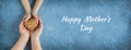 Happy mother`s day.Heart in the hands of daughter and mother on a blue background.I love you.Love and health in the family.Banner Royalty Free Stock Photo