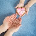 Happy mother`s day.Heart in the hands of my daughter and mother on a blue background.I love you.Love and health in the family. Royalty Free Stock Photo
