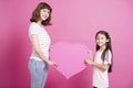 Mom and daughter showing love symbol