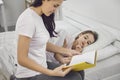 Happy Mother`s Day. Mother and daughter are reading a book at home. Royalty Free Stock Photo