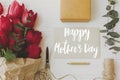 Happy mother`s day. Happy mother`s day text on card and red tulips, gift, pencil, scissors and twine on rustic white wood, flat Royalty Free Stock Photo