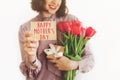 Happy mother`s day text on greeting card. happy woman holding c Royalty Free Stock Photo