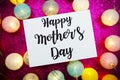 Happy Mother`s Day text on paper card with LED cotton balls decorate on pink background