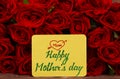 Happy Mother`s day text with Red roses in a bunch as a background. Royalty Free Stock Photo