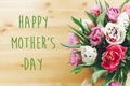 Happy Mother`s Day text sign on beautiful double peony tulips bouquet in vase on wooden table. Stylish floral greeting card. Than