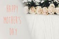 Happy Mother`s Day text sign at white roses on wooden background. Floral greeting card. Stylish border of white flowers. Mothers Royalty Free Stock Photo