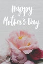 Happy mother`s day. Happy mother`s day text and  tender peony floral border on white wood flat lay. Stylish floral greeting card Royalty Free Stock Photo