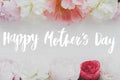 Happy mother`s day. Happy mother`s day text and  tender peony floral border on white wood flat lay. Stylish floral greeting card Royalty Free Stock Photo