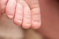 Happy Mother`s day. toes of the newborn baby. macro little feet