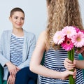 Happy Mother`s Day, Women`s day or Birthday background. Cute little girl giving mom bouquet of pink gerbera daisies. Loving mother Royalty Free Stock Photo