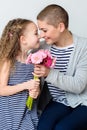 Happy Mother`s Day, Women`s day or Birthday background. Cute little girl giving mom, cancer survivor, bouquet of flowers. Royalty Free Stock Photo