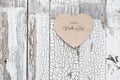 Happy Mother`s Day written on a heart-shaped card on a rustic old wall, doors