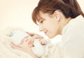 Happy Mother and Sleeping Newborn Baby, mom looking to New Born Royalty Free Stock Photo