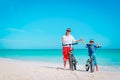 Happy mother and son biking at beach Royalty Free Stock Photo