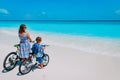 Happy mother and son biking at beach Royalty Free Stock Photo