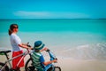 Happy mother and son biking at beach Royalty Free Stock Photo