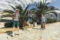 Mother, son and daughter walking together at seaside with luggage backpack. Travel, tourism,  family concept Royalty Free Stock Photo