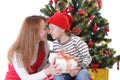 Happy mother and son having fun under Christmas tree Royalty Free Stock Photo