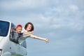 Happy mother and son looking out from windows and enjoying road trip. Family travelling by car Royalty Free Stock Photo