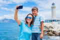 Happy mother and son making selfie in front of Patras lighthouse, Peloponnese, Greece. Royalty Free Stock Photo