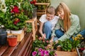 Mother and Son Gardening Together at City Balcony Royalty Free Stock Photo