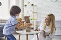 Happy mother and son play board games in the living room. Family has fun playing genga at home Royalty Free Stock Photo