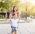 Happy mother and son playing swing Royalty Free Stock Photo
