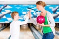 Mother and son playing together at bowling center Royalty Free Stock Photo