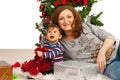 Happy mother and son under Xmas tree Royalty Free Stock Photo