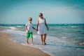 Happy mother and son walk on tropical beach Royalty Free Stock Photo