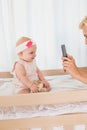 Happy mother taking a picture of her baby girl Royalty Free Stock Photo