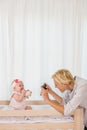 Happy mother taking a picture of her baby girl Royalty Free Stock Photo
