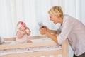 Happy mother taking a picture of her baby girl Royalty Free Stock Photo