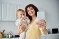 happy mother taking selfie on smartphone Royalty Free Stock Photo