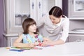 Happy mother teach her daughter to paint. Royalty Free Stock Photo