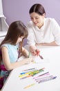 Happy mother teach her daughter to paint. Royalty Free Stock Photo