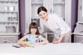 Happy mother teach her daughter to paint. Royalty Free Stock Photo