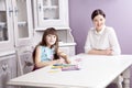 Happy mother teach her daughter to paint. Royalty Free Stock Photo