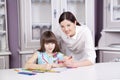 Happy mother teach her daughter to paint. Royalty Free Stock Photo