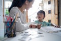 Mother teaching her daughter the basic to read and write Royalty Free Stock Photo