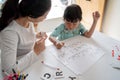 Mother teaching her daughter the basic to read and write Royalty Free Stock Photo