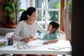 Mother teaching her daughter the basic to read and write Royalty Free Stock Photo