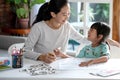 Mother teaching her daughter the basic to read and write Royalty Free Stock Photo